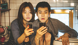 Chinese couple intereacting with their phones istead of each other.