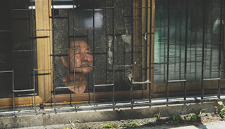 Man in jail looking out